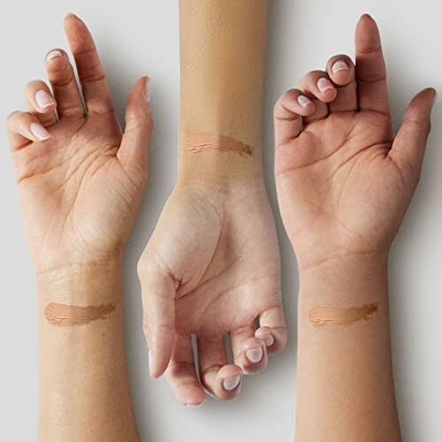 Three arms with different skin tones displaying foundation swatches.